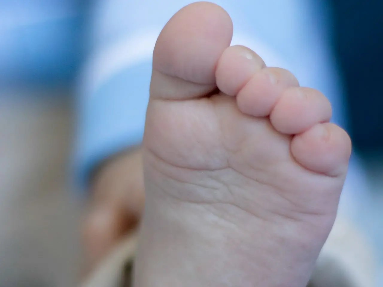 persons feet on white textile